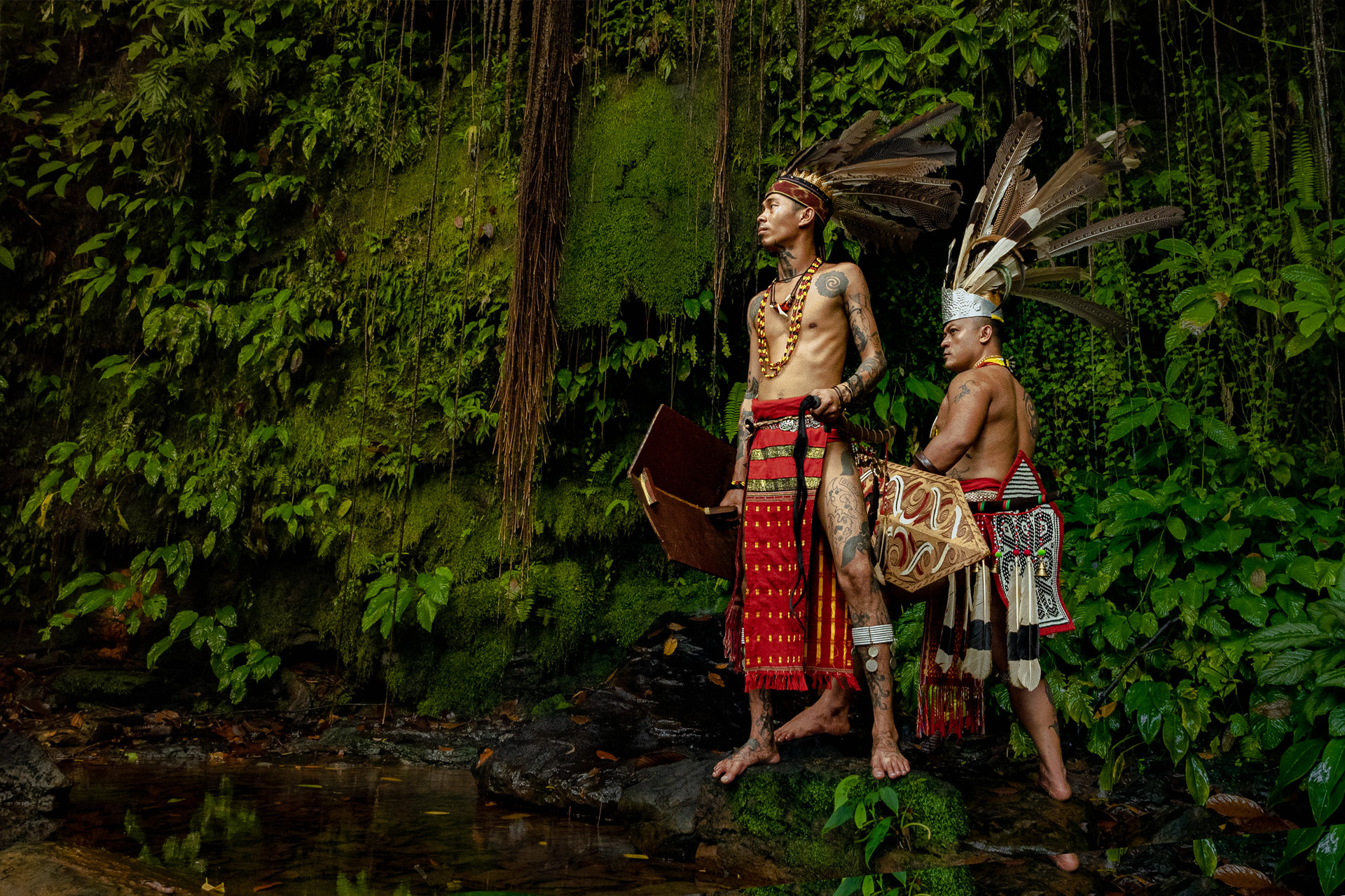 Orang Ulu couple in traditional attire in the rainforest
