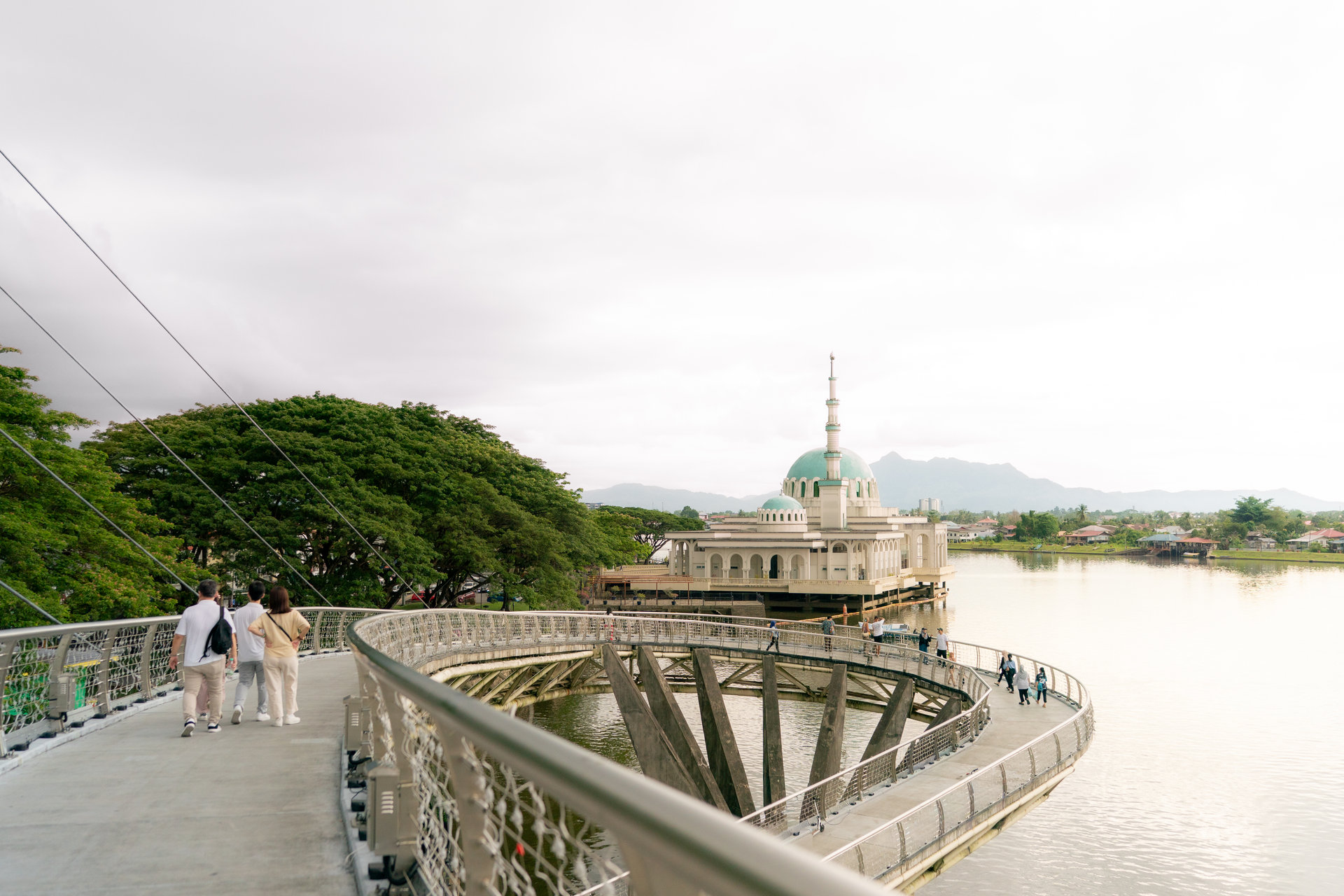 Walkers on the Darul Hana Bridge with the Floating Mosque beyond, Kuching