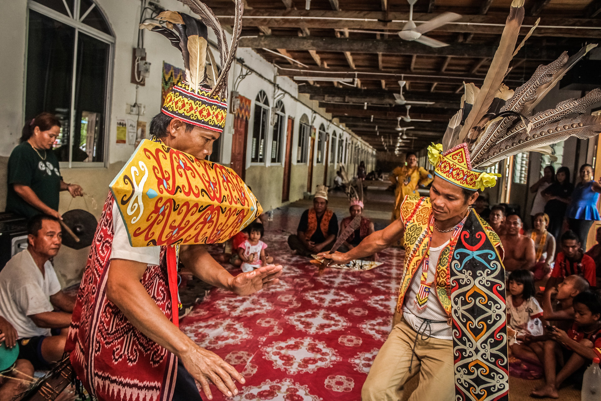 Iban dancers performing the ngajat in a longhouse gallery