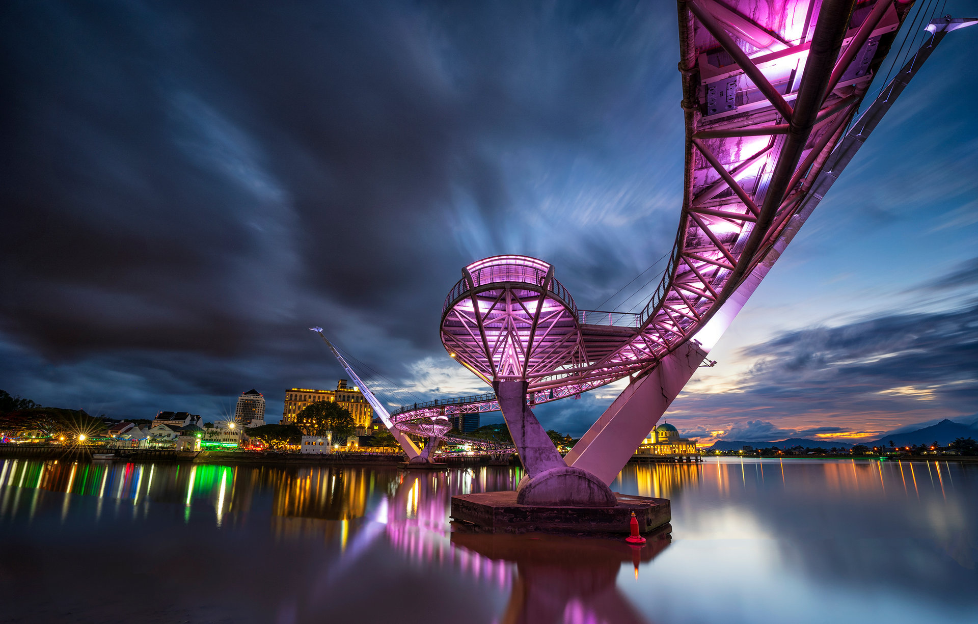 Darul Hana Bridge lit up at dusk over the Sarawak River, Kuching
