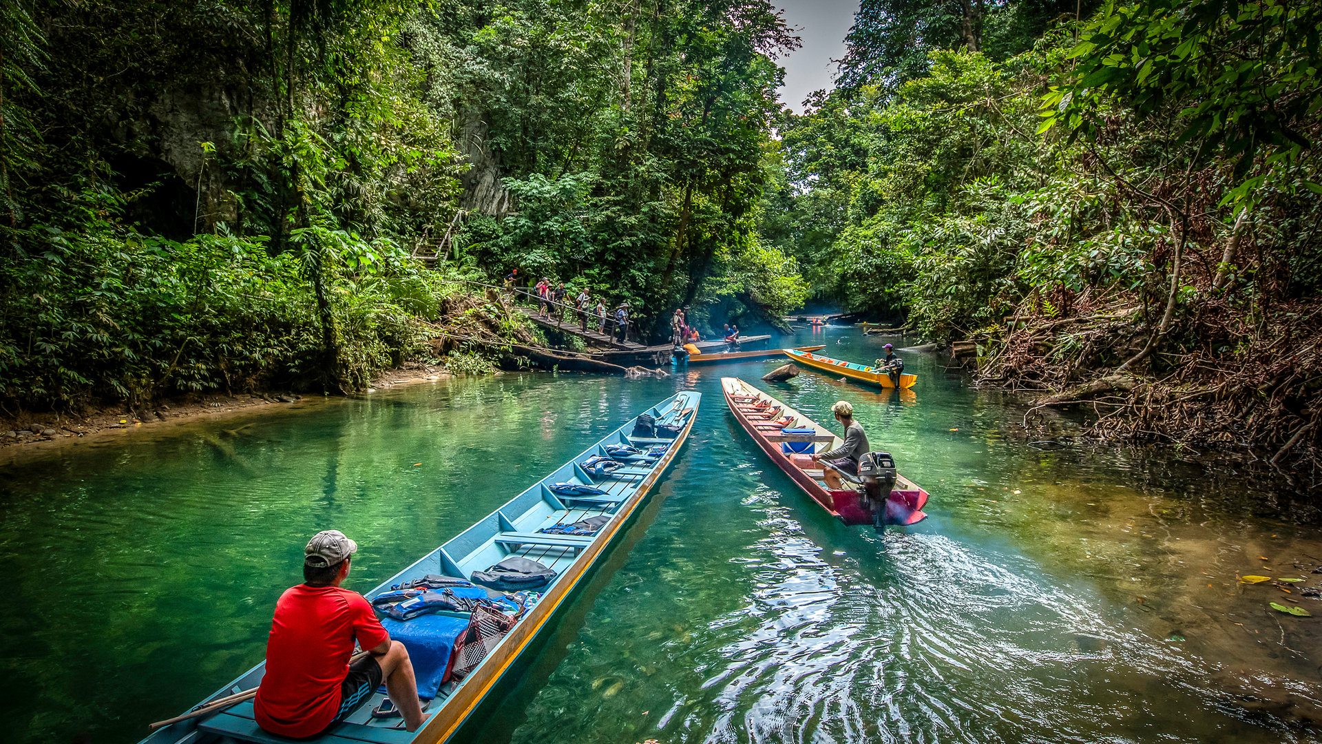 Longboats on a rainforest river in Sarawak