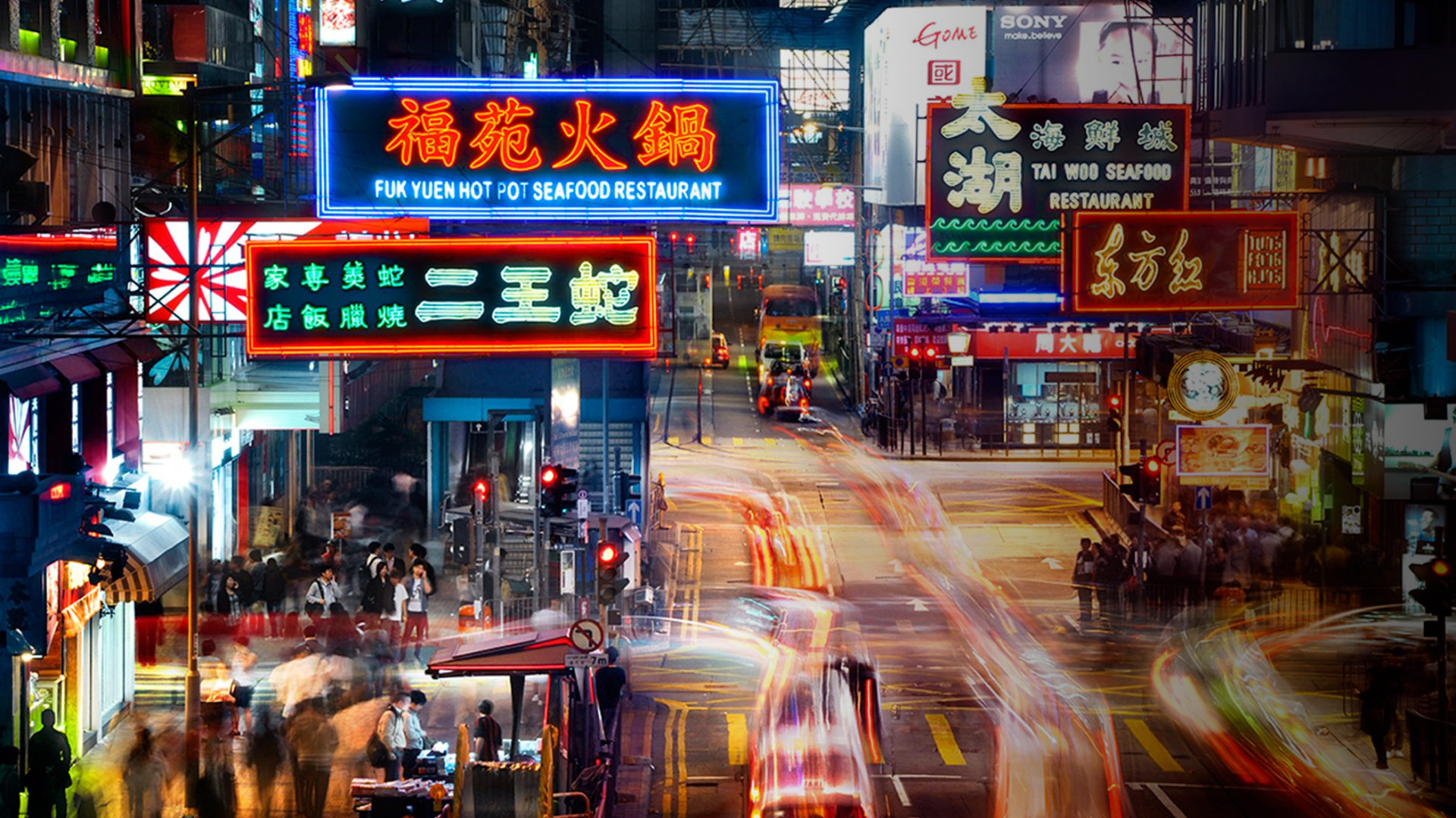 A neon-signed Kowloon street at night