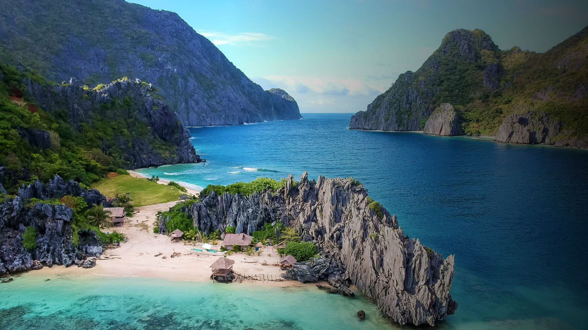 A white-sand cove between limestone cliffs in the Philippines